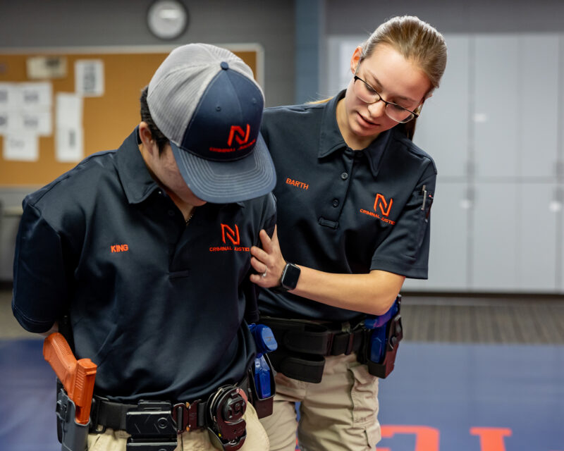 Northland Community & Technical College peace officer students develop real-world skills through hands-on classroom training, practicing positioning and control techniques as part of their law enforcement education.