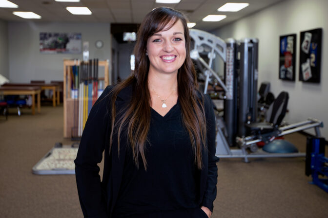 Student stands in front of occupational therapy room