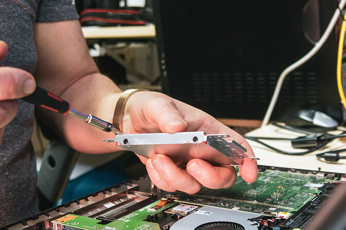 an opened notebook is repaired in a computer workshop