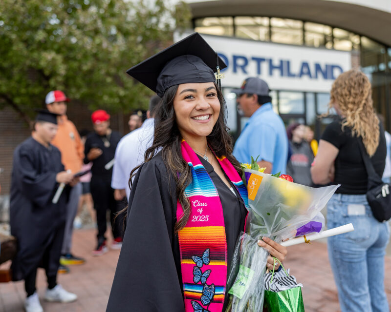 Student outdoors at TRF graduation ceremony.