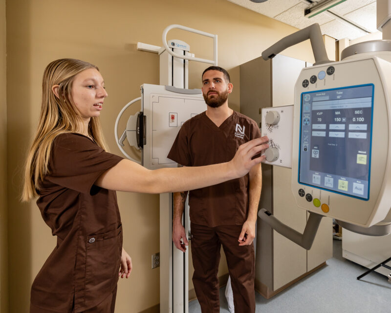 Northland Community & Technical College Radiologic Technology students gain hands-on experience operating diagnostic imaging equipment, adjusting exposure settings and controls as part of real-world clinical training at the East Grand Forks campus.