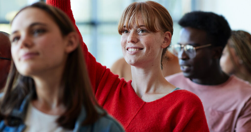 Student raising hand in class