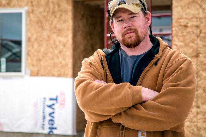 Plumbing instructor in front of worksite