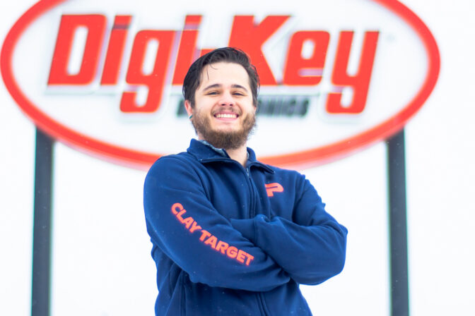 Student stands in front of Digi-Key sign