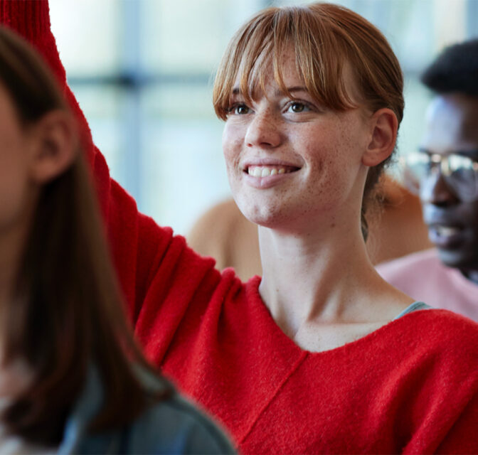 Student raising hand in class