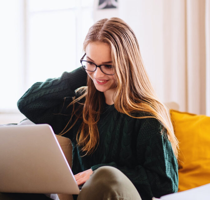 Woman sitting on the couch with her laptop