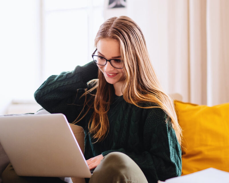 Woman sitting on the couch with her laptop